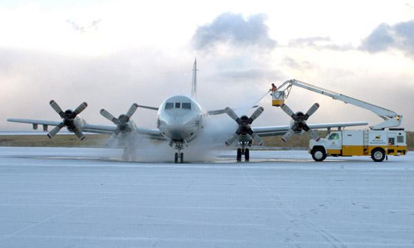 An aircraft is deiced on the runway