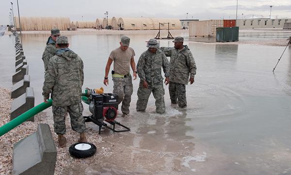 USAF personnel pump water from flooded residential area, Dec 2009, Southwest Asia. Photo by Staff Sgt. Sharon Singer